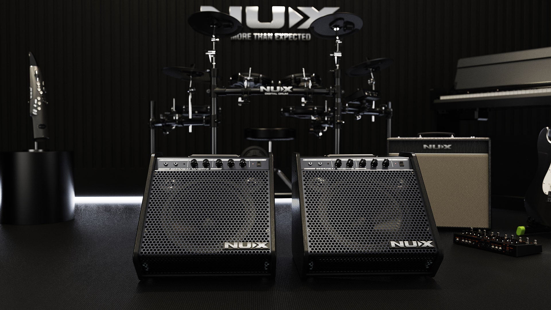 two NUX bass amps in front of an electric drum kit