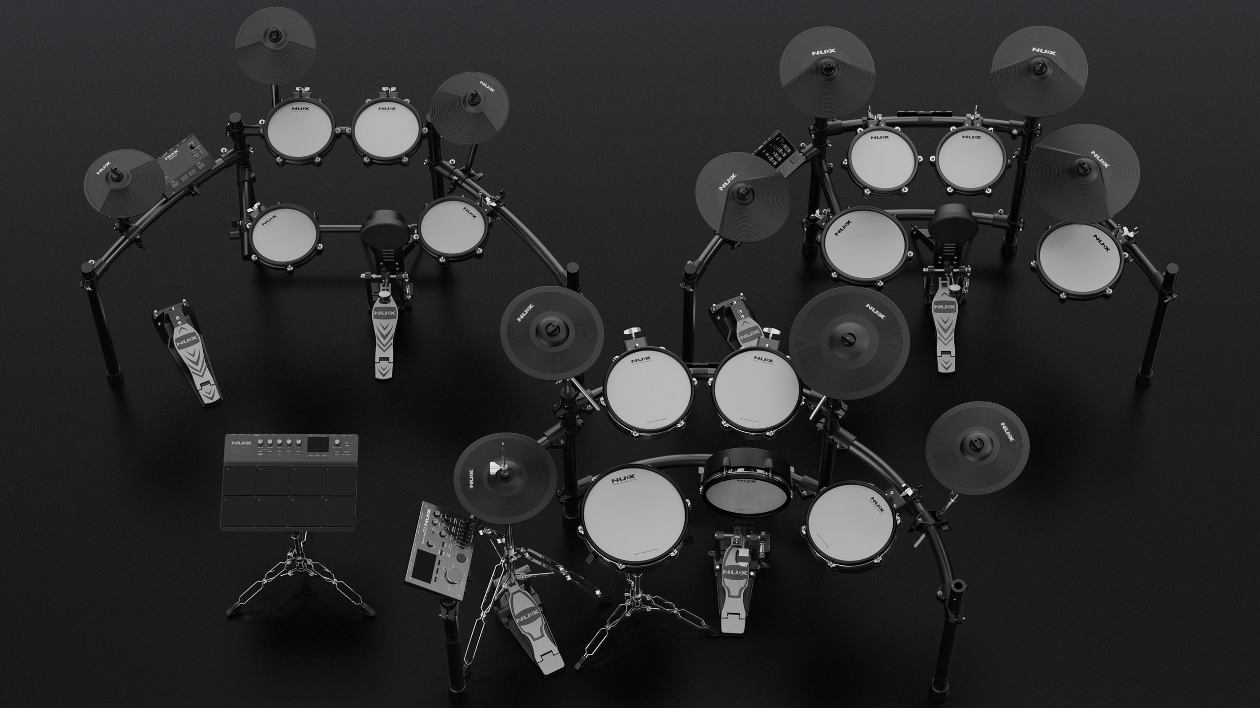 three NUX electric drumkits in dark background