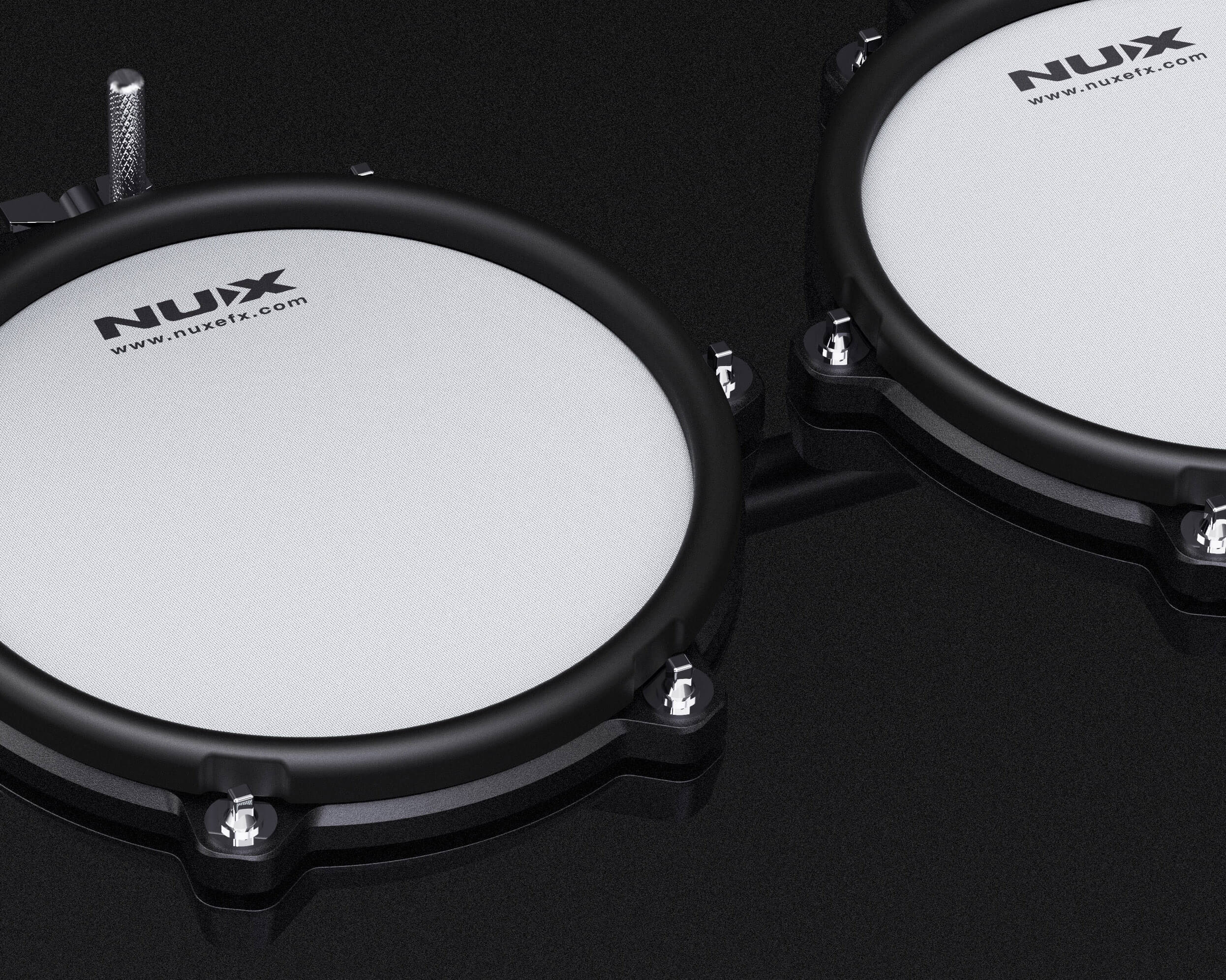 Two NUX electronic drum pads on a black background
