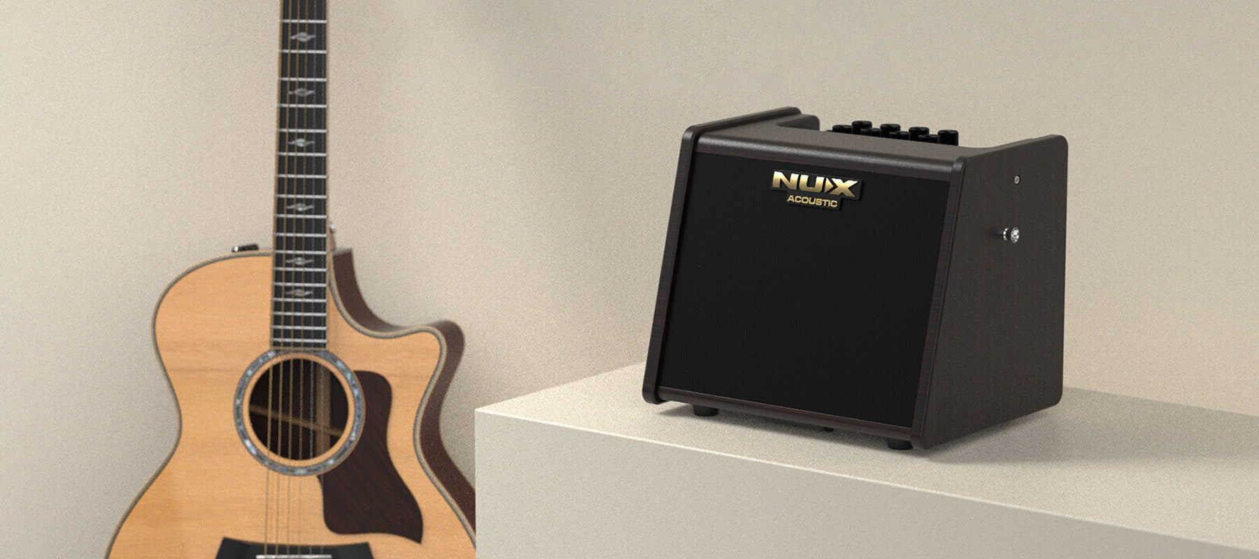 Black NUX AC-25 NUX acoustic guitar amplifier on a white platform with a guitar in the background