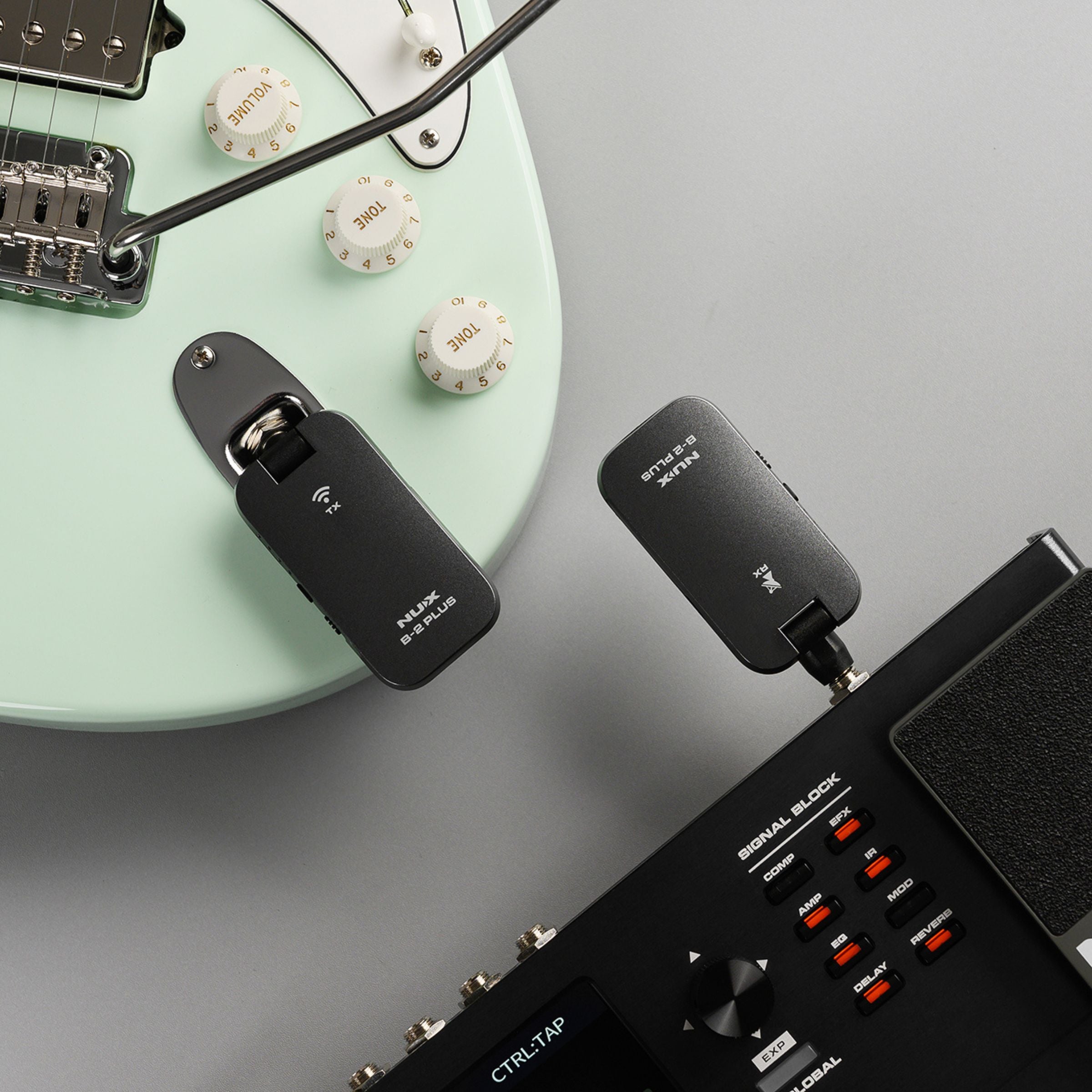 Guitar with B-2 PLUS wireless transmitter and receiver plugged on to a mixer.