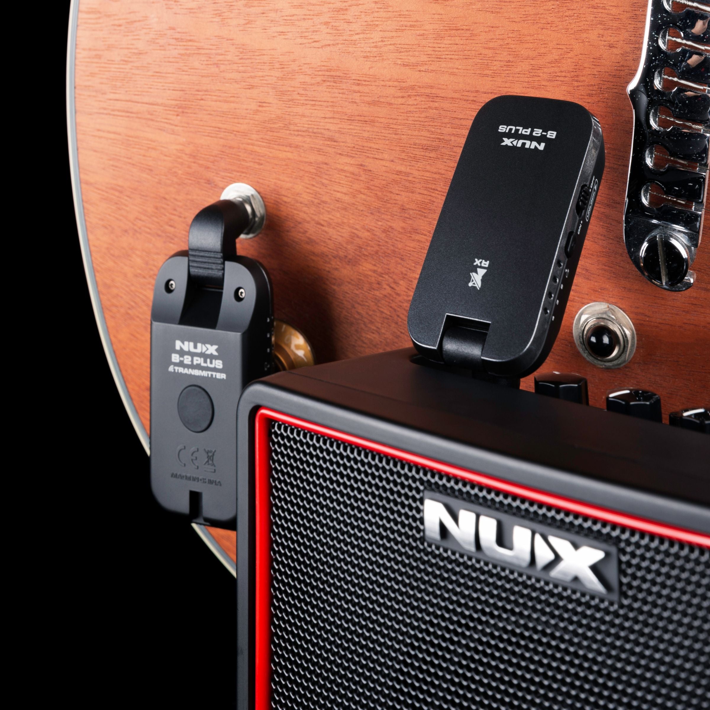 NUX B-2 PLUS wireless guitar transmitter plugged onto a guitar and receiver plugged into a amplifier