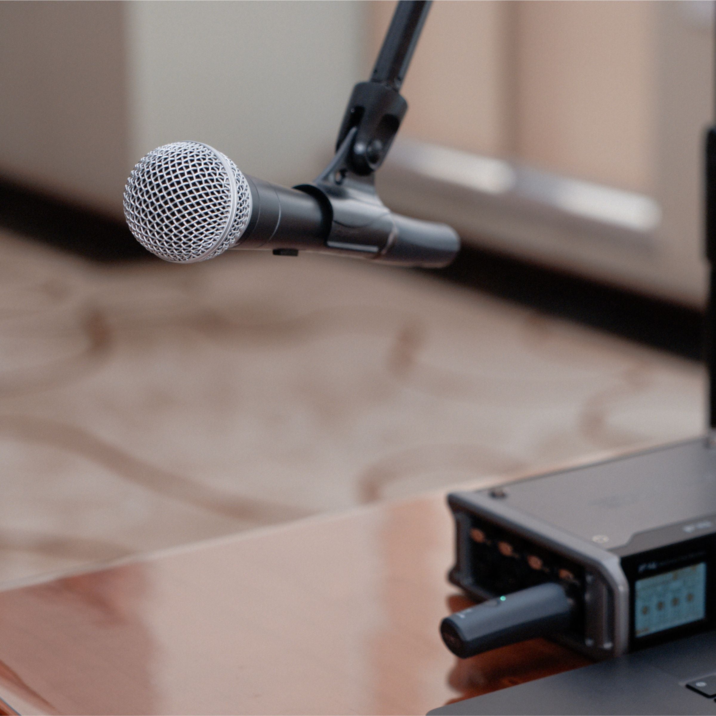 NUX B-3RC wireless microphone on stand with receiver connected to audio interface.