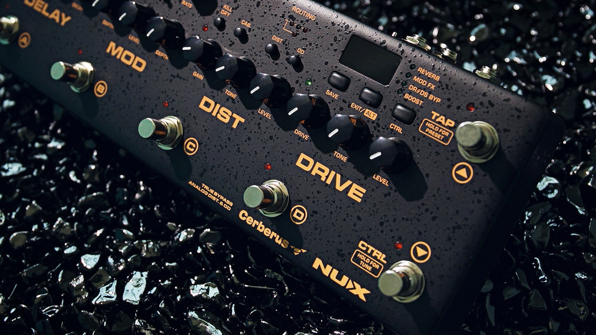 Nux Cerberus guitar effects pedal on a dark, textured surface