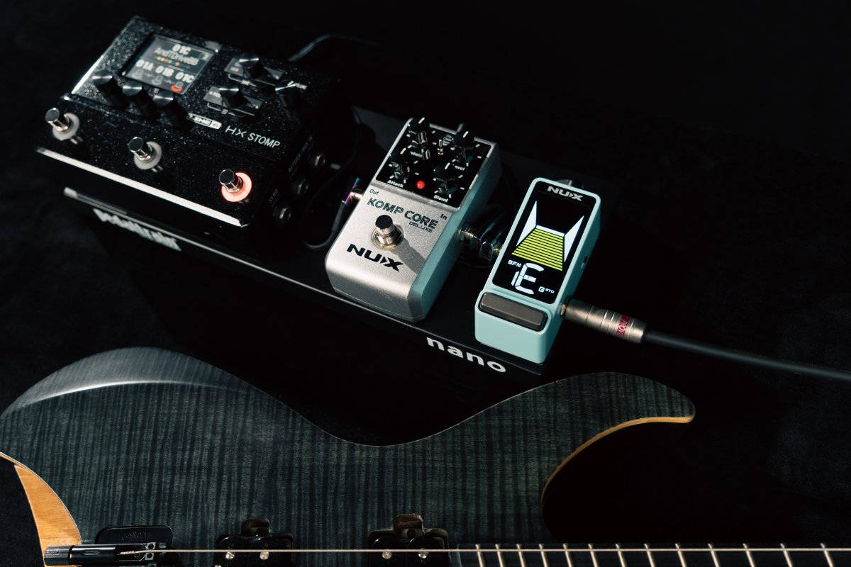 Guitar with effects pedals on a dark background