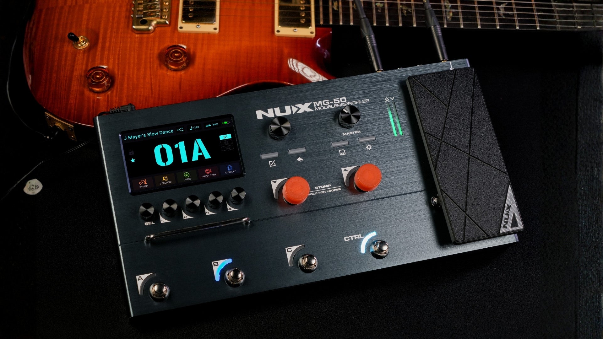 NUX MG-50LI in dark blue/black color on a dark background on top of an electric guitar