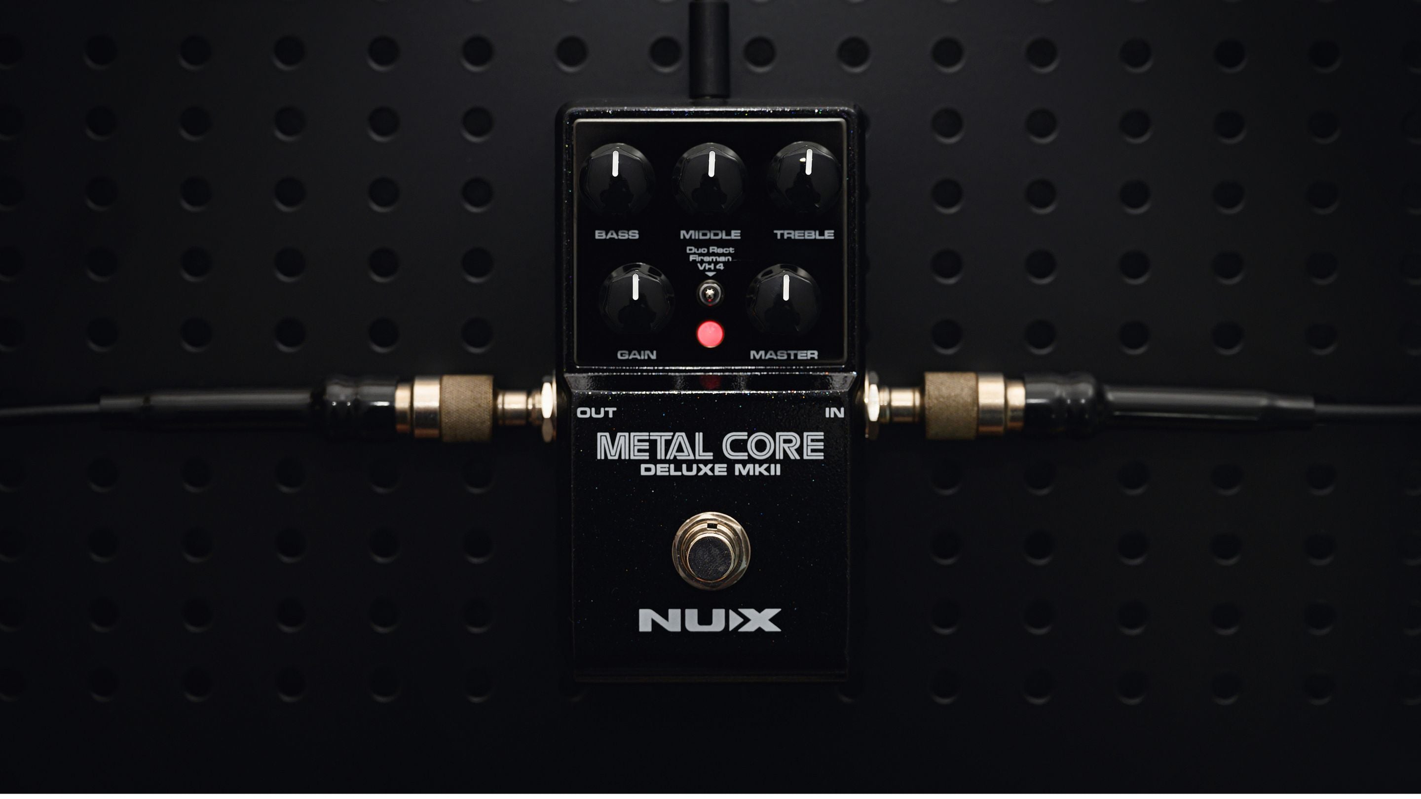 NUX Metal core deluxe MKII with cables plugged in its interface.