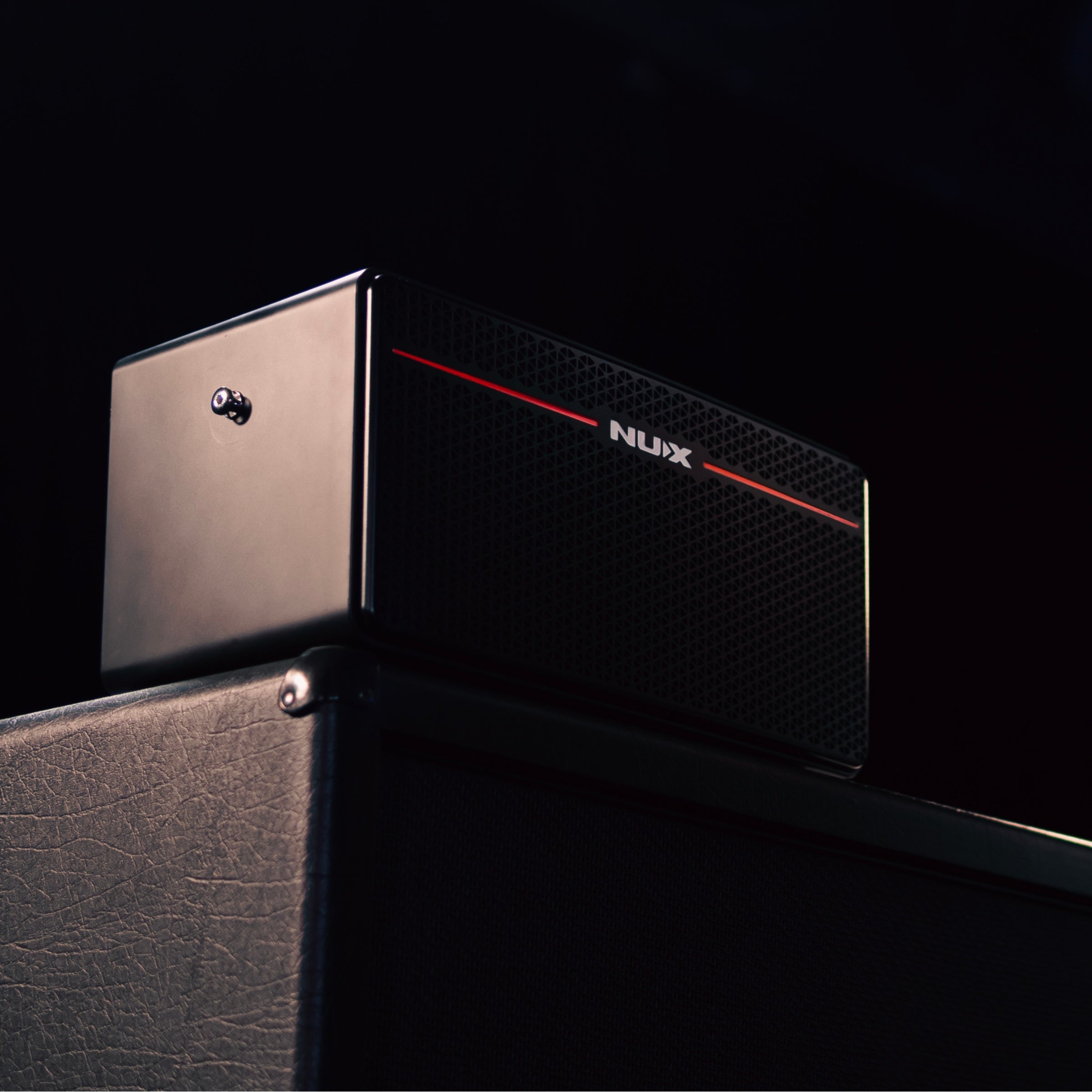 NUX Mighty space guitar amp on top of a amp cabinet