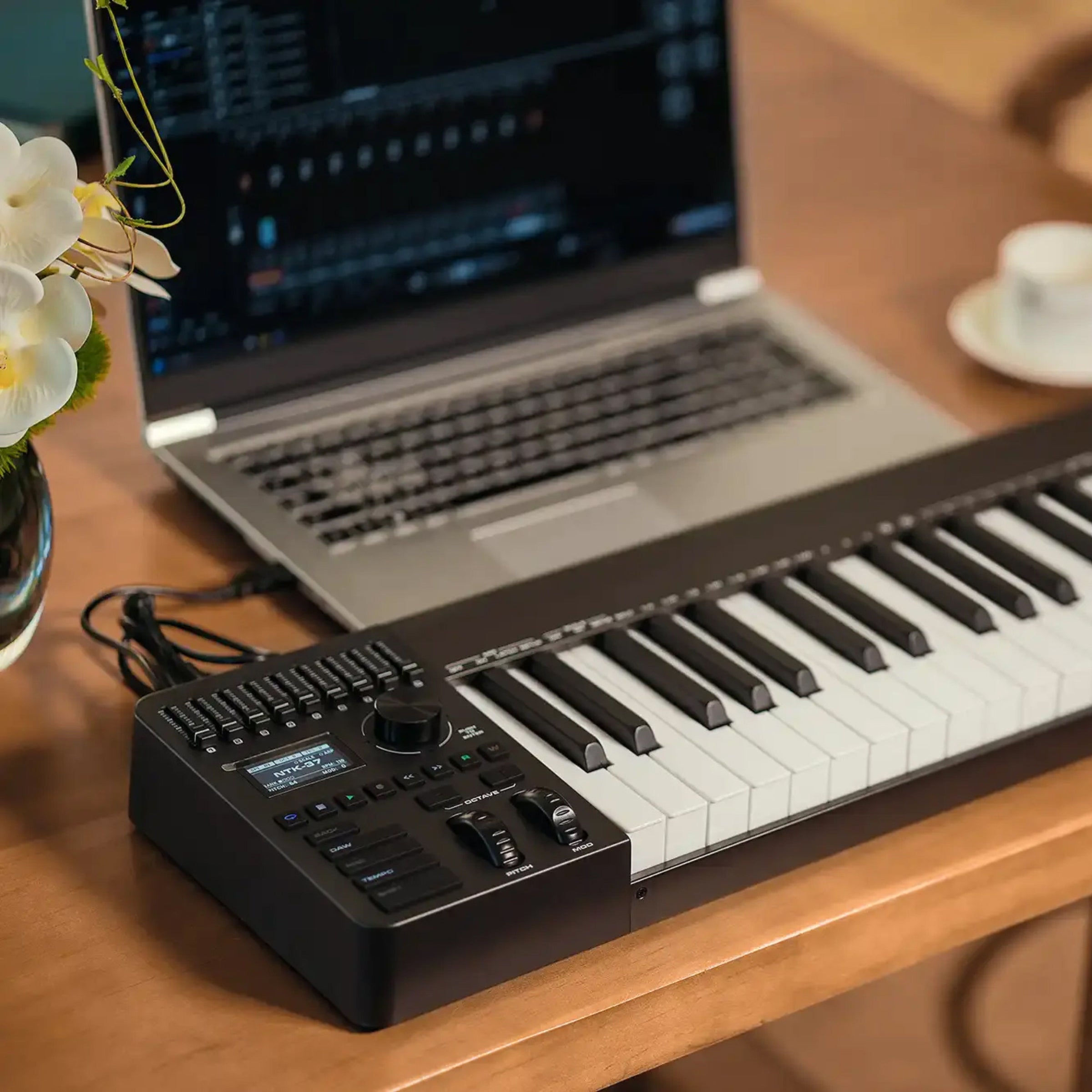 NUX NTK Keyboard controller with laptop on a wooden desk