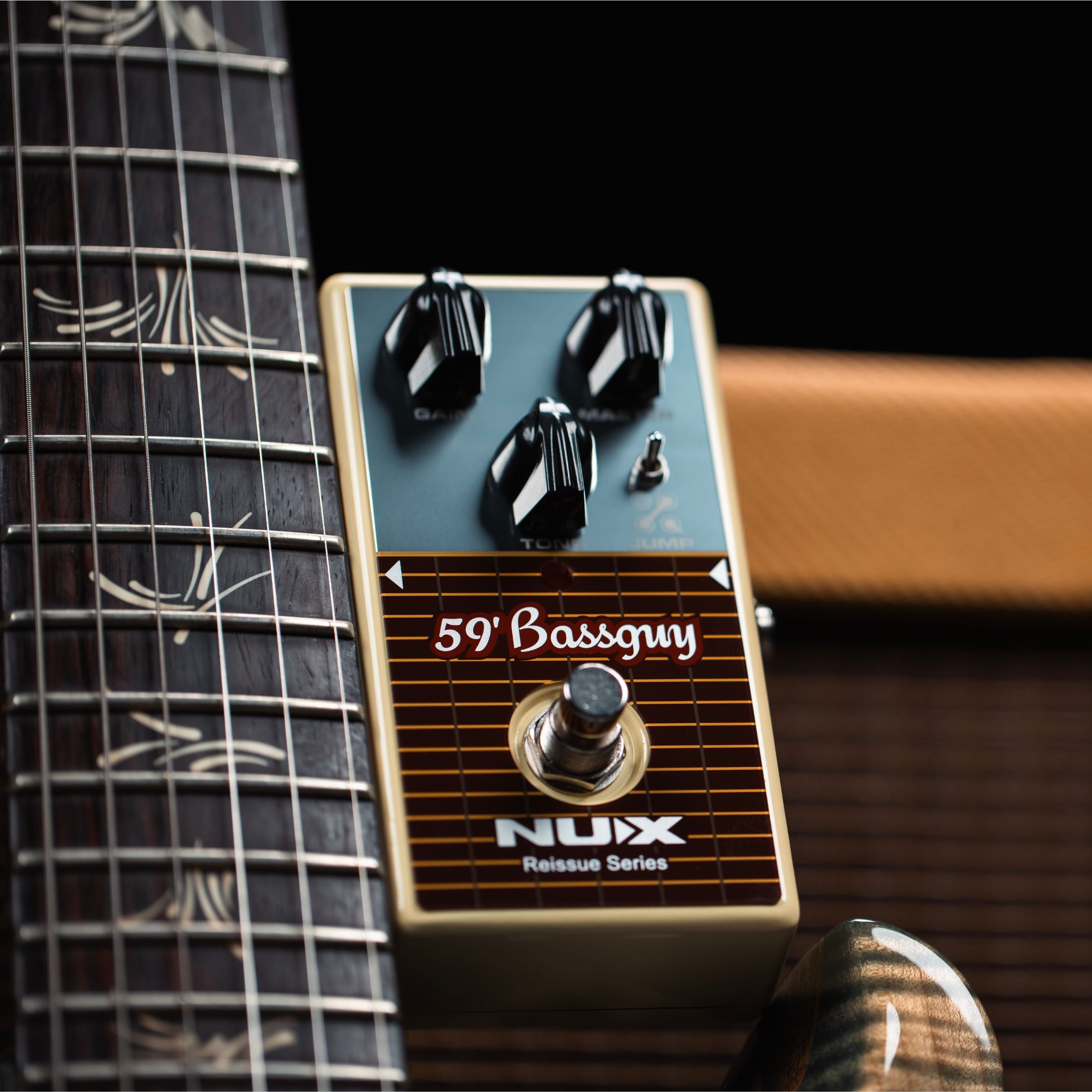 Guitar effects pedal with '59 Bassguy' and 'Nux' branding on a guitar neck background.