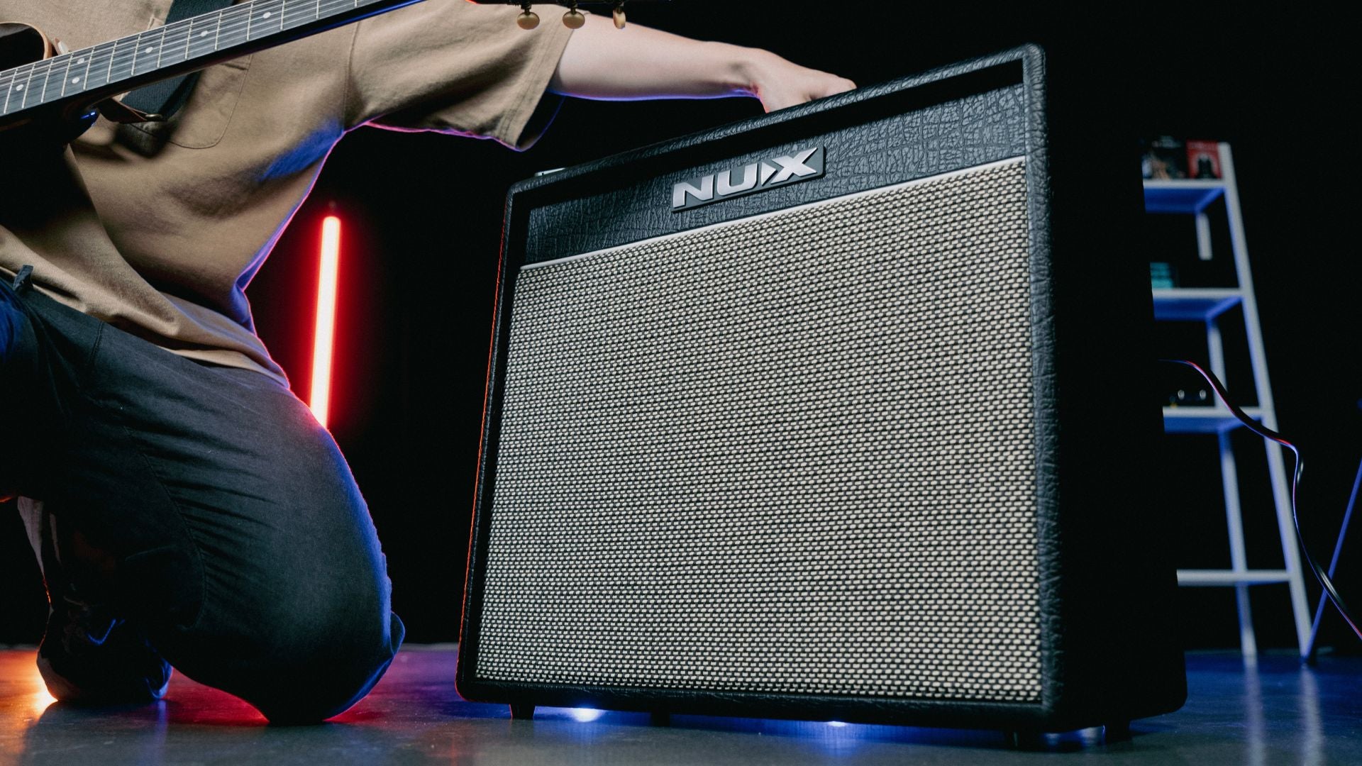 person adjusting NUX mighty 60 guitar amp