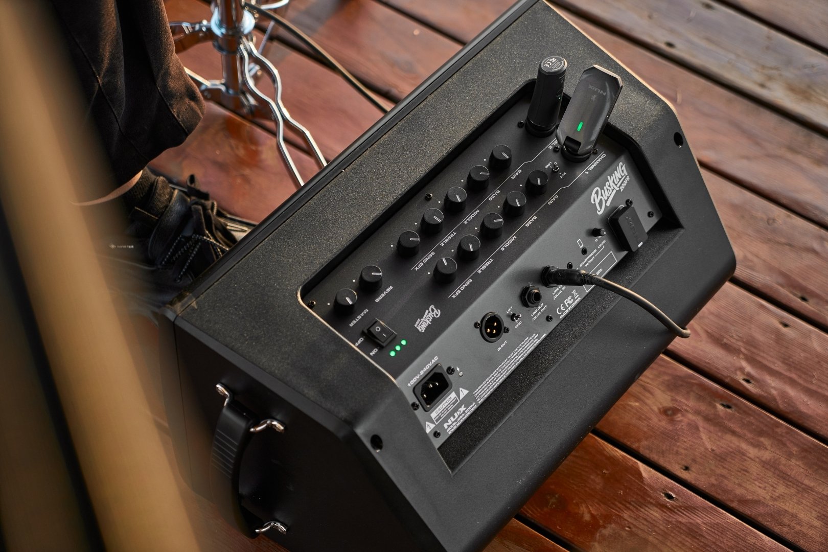 NUX Busking 200FR amp outdoors with wireless mic and guitar plugged in.