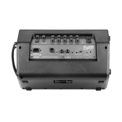 Back of a guitar amplifier with control knobs and ports on a white background