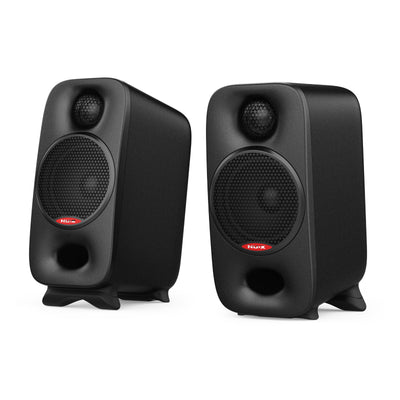 Pair of black nux studio monitor speakers with visible brand logo on a white background