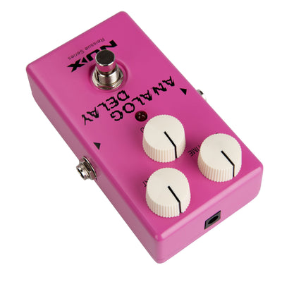 Pink NUX guitar effects pedal with knobs and a footswitch on a white background