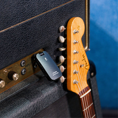 NUX B-2 PLUS wireless guitar receiver plugged on to an amplifier.