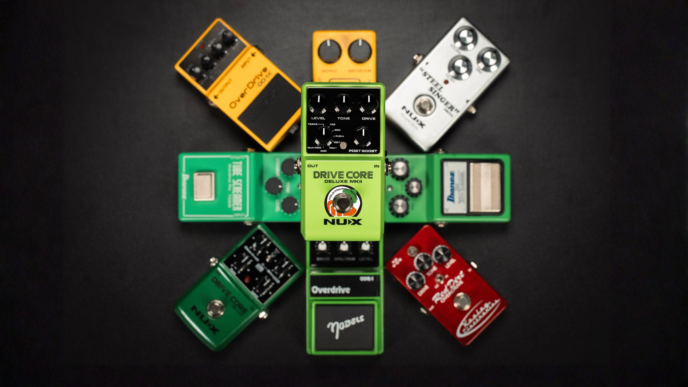 Collection of various guitar effect pedals on a black background