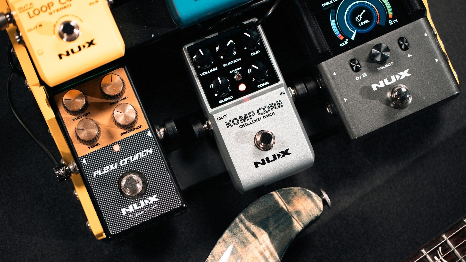Collection of NUX guitar effect pedals on a dark background