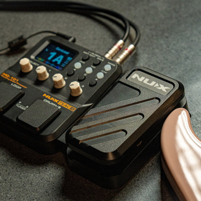 Nux MG-101 audio effects pedal on a gray surface