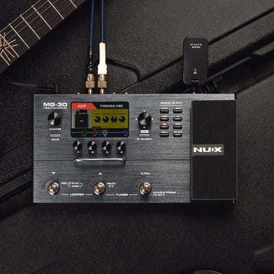 NUX MG-30 guitar effects pedal on a dark background with a guitar