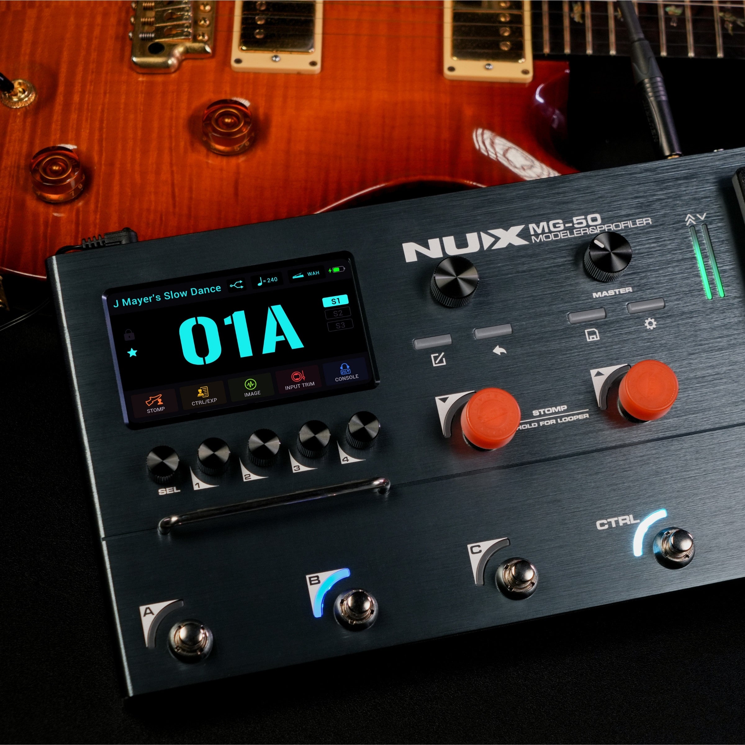 Nux MG-50 guitar effects pedal with a guitar in the background