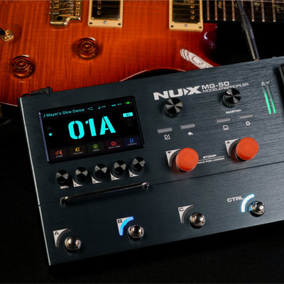 Nux MG-50 guitar effects pedal with a guitar in the background