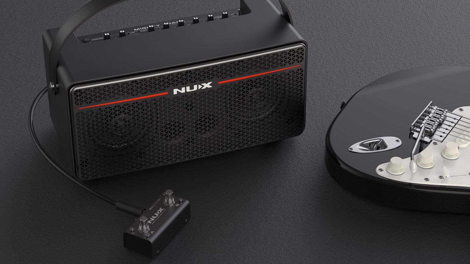 NUX mighty space with the included footswitch next to an electric guitar