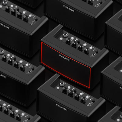NUX guitar amplifiers arranged in a pattern on a black background