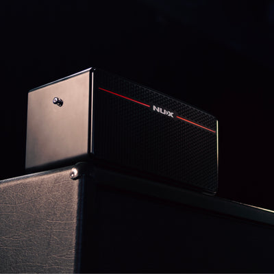 NUX Mighty space guitar amp on top of a amp cabinet