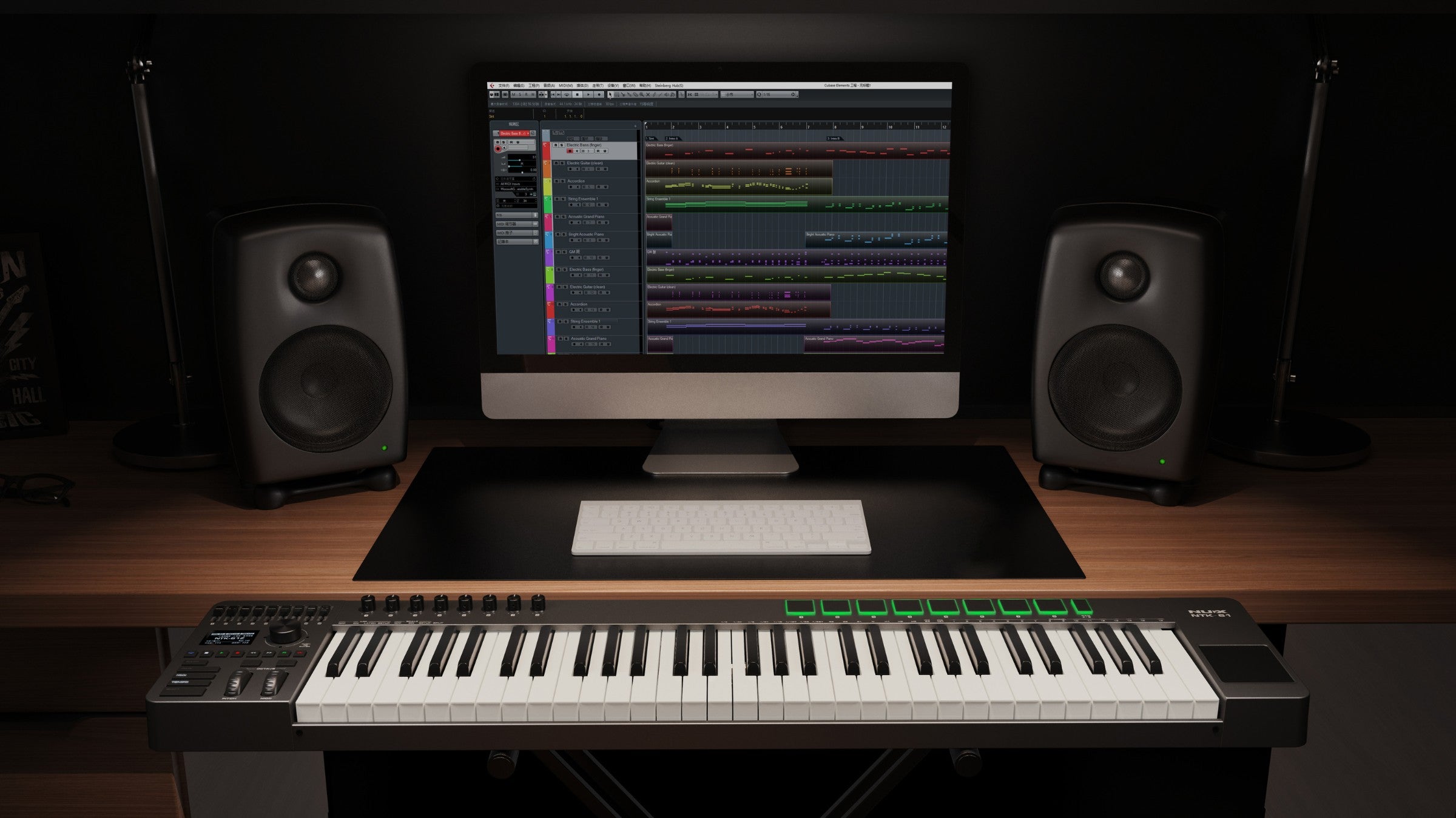 Music production setup with computer, NUX Midi keyboard, and speakers on a dark background