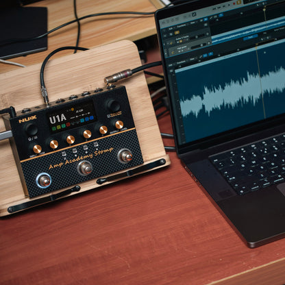NUX amp academy stomp connected to a laptop with audio editing interface via usb.
