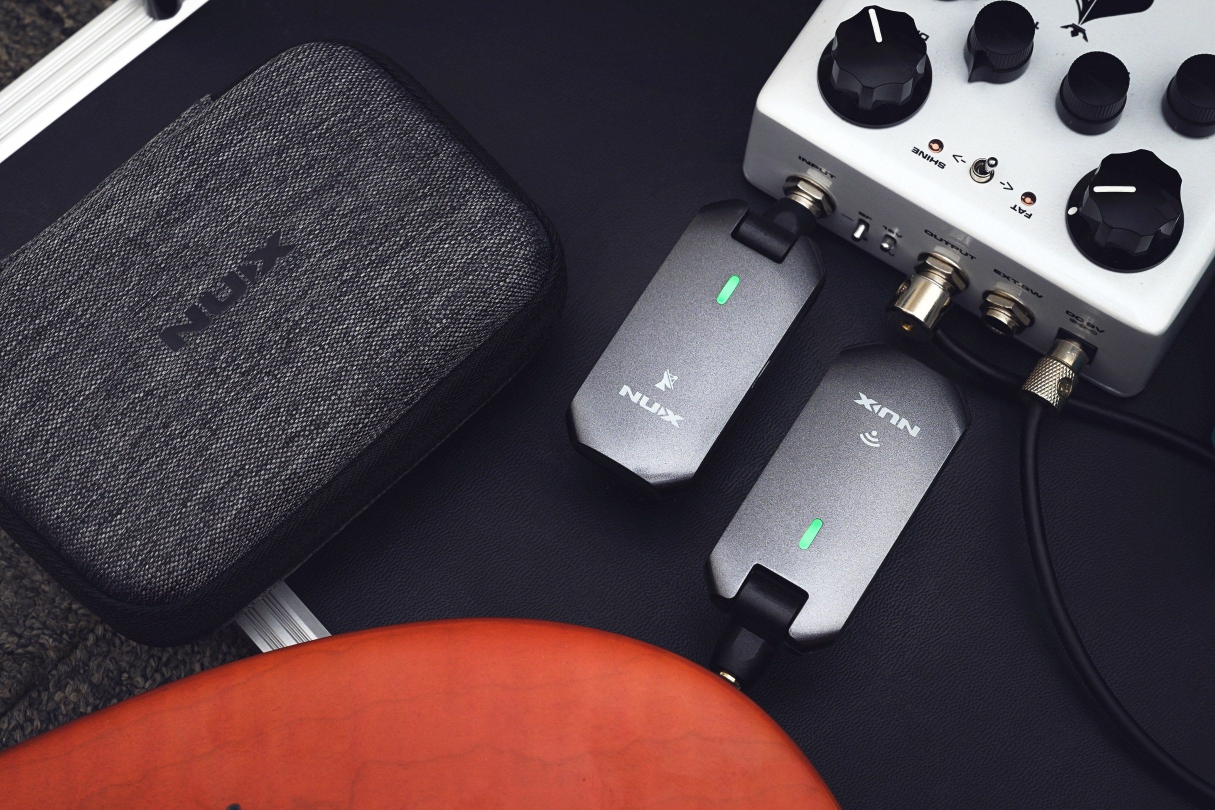 NUX Guitar wireless system connected to a guitar and effects pedal