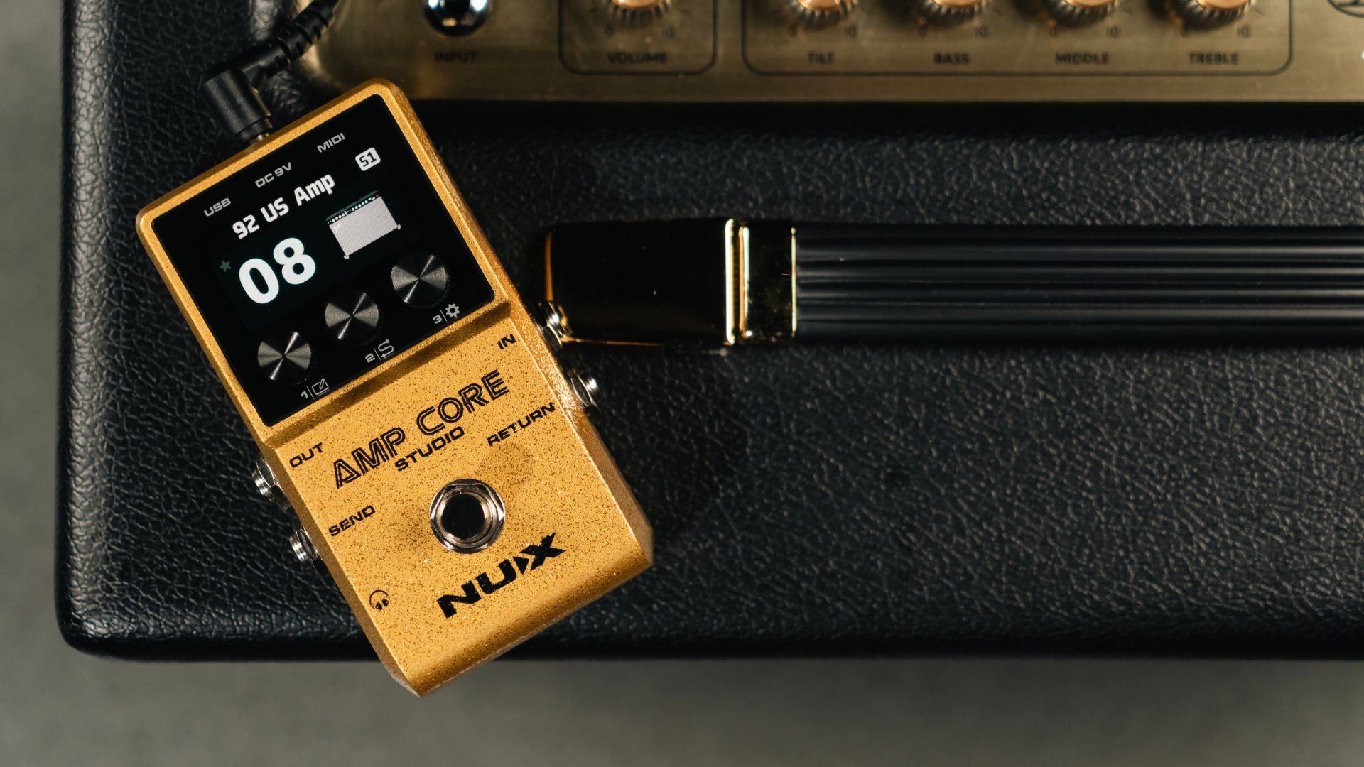 Nux Amp Core guitar effects pedal on a black background