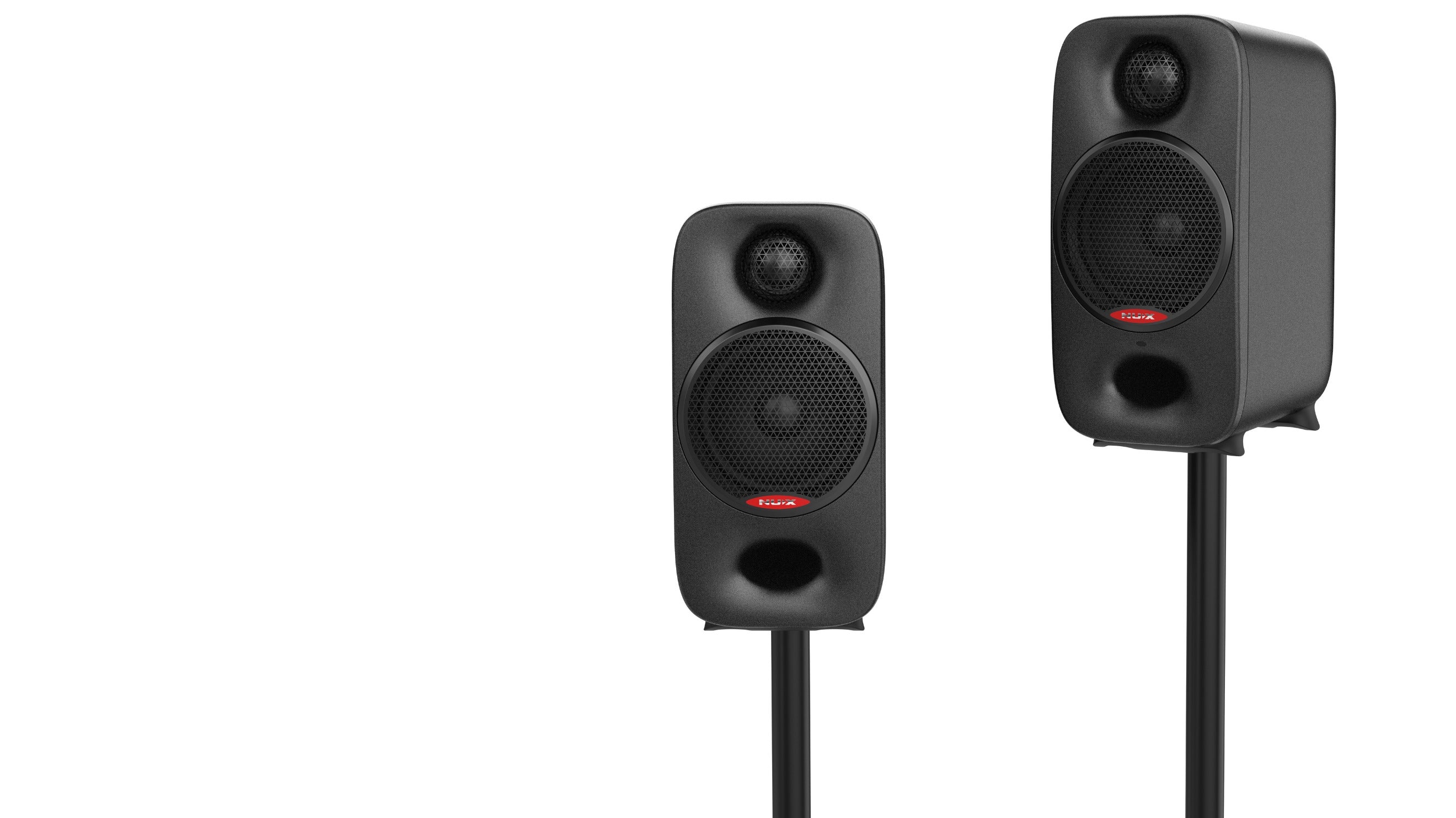 Two black NUX studio monitors on stands against a white background