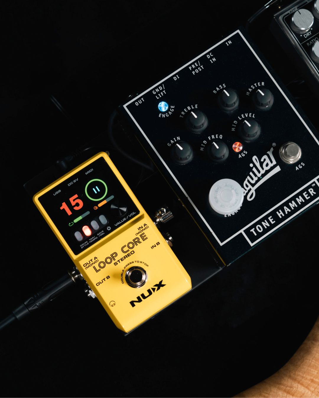 Nux Loop Core pedal and Aguilar Tone Hammer amplifier on a dark background